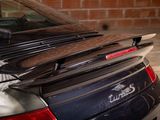 an image of a car parked in a garage with a surfboard on top of it