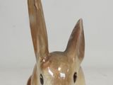 two small ceramic rabbits sitting next to each other on a table