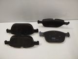 three pairs of black brake pads on a white surface
