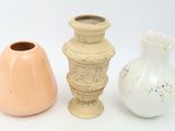 three vases sitting next to each other on a white surface
