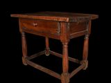 an old wooden table with a drawer underneath it on a black background