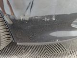 a close up of a car ' s front bumper with a person standing on it