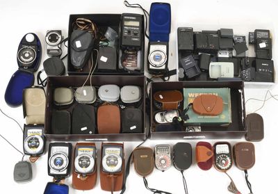 many different types of cameras and accessories in a box