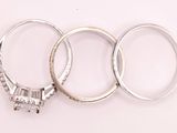 three wedding rings sitting next to each other on a white surface