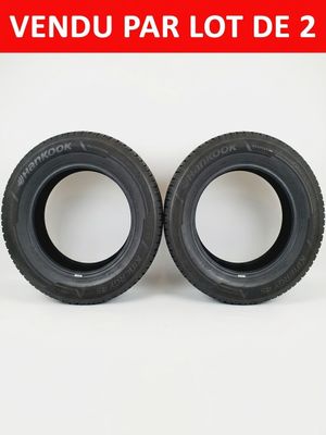 a pair of tires with a red background and the words vendu par lot de 2