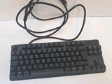 a black keyboard with a cord attached to it