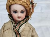 a doll that is wearing a hat and scarf