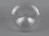 close up of a clear glass ball on a gray surface