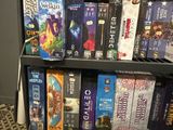 a book shelf full of board games on display