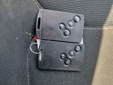 two keys attached to the back of a car seat