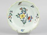une assiette blanche décorée de fleurs et de papillons colorés