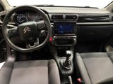 the interior of a car with a steering wheel and dashboard controls