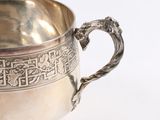a silver cup that is sitting on a table