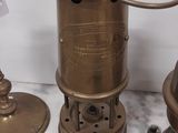 three different types of antique brass lamps on a table