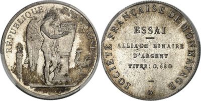 a silver coin with a man holding a sword on top of it