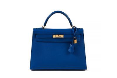 a blue leather handbag with a gold lock on the handle