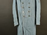 an image of a blue coat on a mannequin stand