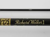 a close up of a pair of fishing rods on a white surface