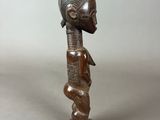 a wooden statue of a woman with a headdress on her head
