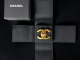 a black box with a gold ring on top of it