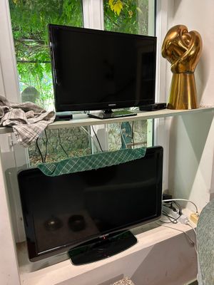 a television on a stand in the corner of a living room