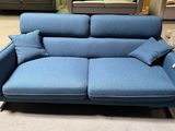 a blue couch that is sitting in the middle of a room