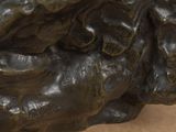 a statue of a man holding a bird on his arm