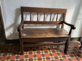 a wooden bench that is sitting on a tiled floor