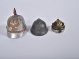 three different types of helmets are sitting on a white surface