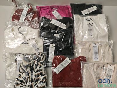 a lot of clothes that are sitting on a table