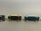 three different color switches sitting next to each other on top of a table