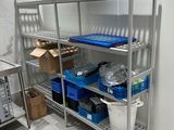a metal shelving with a lot of items on it