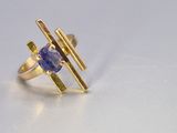 yellow gold ring with a tan tan sapphire stone and a thin band