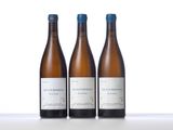 three bottles of wine are lined up on a white surface