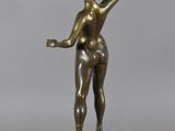 bronze statue of a woman holding a tennis racquet on a marble base