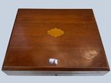 a small wooden box with a gold design on it