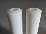 two white candles that are sitting on a table