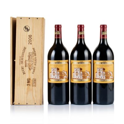 three bottles of red wine in a wooden box next to a wooden box
