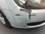 a close up of a car ' s front bumper with a sticker on it