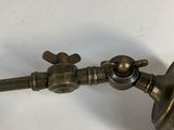 a metal object on a white surface with a light on it