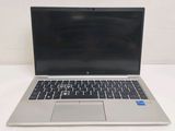 an open laptop computer sitting on top of a white table