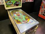 a pinball machine and a pinball machine in a room