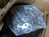 a cardboard box with a record in it that has been wrapped in plastic