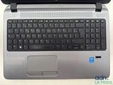 a laptop with a black keyboard on a white table