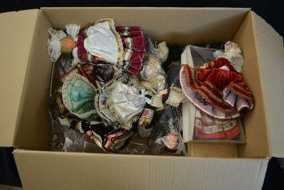 a cardboard box filled with assorted items on a table