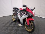 a picture of a red and white motorcycle parked on a black and white checkered floor