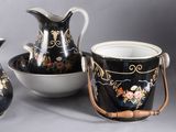 three vases and a bowl sitting on a table