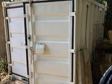 a white container sitting in the middle of a yard