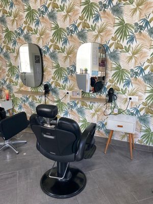 a picture of a hair salon with chairs and mirrors