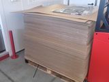 a stack of cardboard sitting on a pallet next to a door